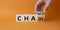 Chance vs Chaos symbol. Businessman hand Turnes cube and changes word Chaos to Chance. Beautiful orange background. Psychology and