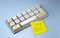 Change password. Keyboard with letters qwerty and yellow office sticker on a blue background. 3d render