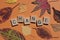 Change, word in wooden letters with autumn leaves