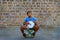 Chania, Crete / Greece - September 15 2019 Young boy playing music on street trying to ear money with music.