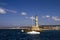 Chania lighthouse with sailboat