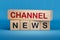 Channel News symbol. Wooden blocks with words \'Channel News\'.