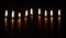 Chanukah candles glowing in the dark