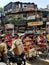 Chaotic scene full of tricycles in Old Delhi.