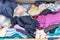 Chaotic wardrobe and sloppy closet shows many outfits of a woman with shopping addiction and many clothes like pullovers, shirts a