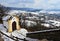 Chapel of Banska Stiavnica calvary near upper church during winter season with snowy stairway and part of cityscape in background