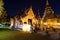 Chapel and golden pagoda at Wat Phra Singh Woramahawihan in Chiang Mai at twilight or night with stars in sky