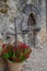 Chapel at Mission Espada with red flowers