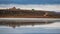 Chapel over the hill, track and lake reflections