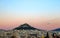 The Chapel of St George viewed over the rooftops of Athens Greece at sunset