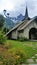 Chapel with Steeple Cross beneath snow-capped French Alps