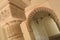 Chapiter column and Nasrid arch in muslim palace of Alcazaba, Malaga, Spain