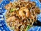 Char Kuey Teow .Malaysian food on blue and white dish.