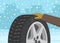 Character checks the winter tire. Perspective close-up studded tire.