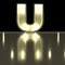 Character U font with reflection. Light bulb glowing letter alph