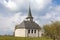 Characteristic church in the green field in the Swiss Alps of the Canton Jura