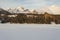 Characteristic Hotel in the High Tatras over the frozen Lake Strbske pleso and beautiful mountain view.