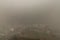 Characteristic view of a modern city skyline covered in a dense smog and air pollutant before a rain