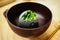 Charcoal coated a scoop of homemade green tea ice cream in Japanese teahouse dessert cafe. Tasty exotic fusion dessert.