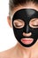 Charcoal face mask peel off facial treatment Asian beauty woman using chemical black mask therapy