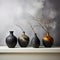 Charcoal vases on marble, vividly juxtaposed with white wall surroundings