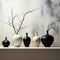 Charcoal vases on marble, vividly juxtaposed with white wall surroundings