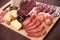 Charcuterie board with cured meat and olives