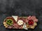 Charcuterie board or Italian antipasti of assorted cheeses, meats, and appetizers.