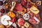 Charcuterie boards of assorted cheeses, meats and appetizers, above view table scene on rustic wood