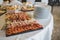 Charcuterie boards with various fruits, cheese, and meat at a wedding dinner