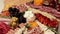 Charcuterie and cheese platter rotates smoothly around its axis. Appetizers boards with assorted cheese, salami, ham, grape and