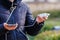 Charger in the female hand of a tourist with a discharged smartphone lifestyle outdoors. Selective focus on charging