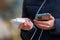 Charger in the female hand of a tourist with a discharged smartphone lifestyle outdoors. Selective focus on charging