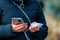 Charger in the female hand of a tourist with a discharged smartphone lifestyle outdoors. Selective focus on charging