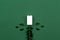 Charging Eco energy or green power illustration with a white battery and sprigs leaves on a green background with copy space for