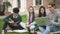 Charismatic american four person talking, sitting along college campus.