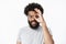 Charismatic friendly african american man with beard, afro hairstyle and pierced nose showing okay gesture over eye and