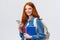 Charismatic friendly-looking european redhead female university student, college girl with backpack and notebooks