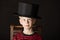 Charismatic little boy wearing an out size top hat