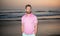 charismatic man with beard in sunset over sea. unshaven guy on morning beach.