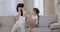Charismatic mature mother with her daughter while sitting in the sofa , using a virtual reality glasses to exploring the