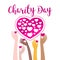 Charity Day Hands of different nationalities hold hearts as good to others.