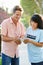 Charity Worker Collecting Sponsorship From Man In Street