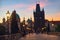 Charles Bridge at dawn: silhouettes of Old Bridge Tower and spires of Old Prague on a sunrise