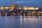 .Charles Bridge on the Vltava River and Prague Castle and the Church of St. Vitus in winter and snow on the roofs in the center of