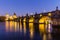 Charles Bridge and Vltava river in Prague in dusk at sunset
