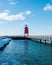 Charlevoix, MI /USA - March 3rd 2018:  Charlevoix Michigans pier leading to its red lighthouse in winter