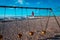 Charlevoix, MI /USA - March 3rd 2018:  A shot of Charlevoix Michigan beach through a swingset