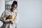 Charming afro woman holds a cup of coffee, posing