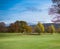 Charming autumn landscape in Scotland - colourful trees, grass, forest, blue sky